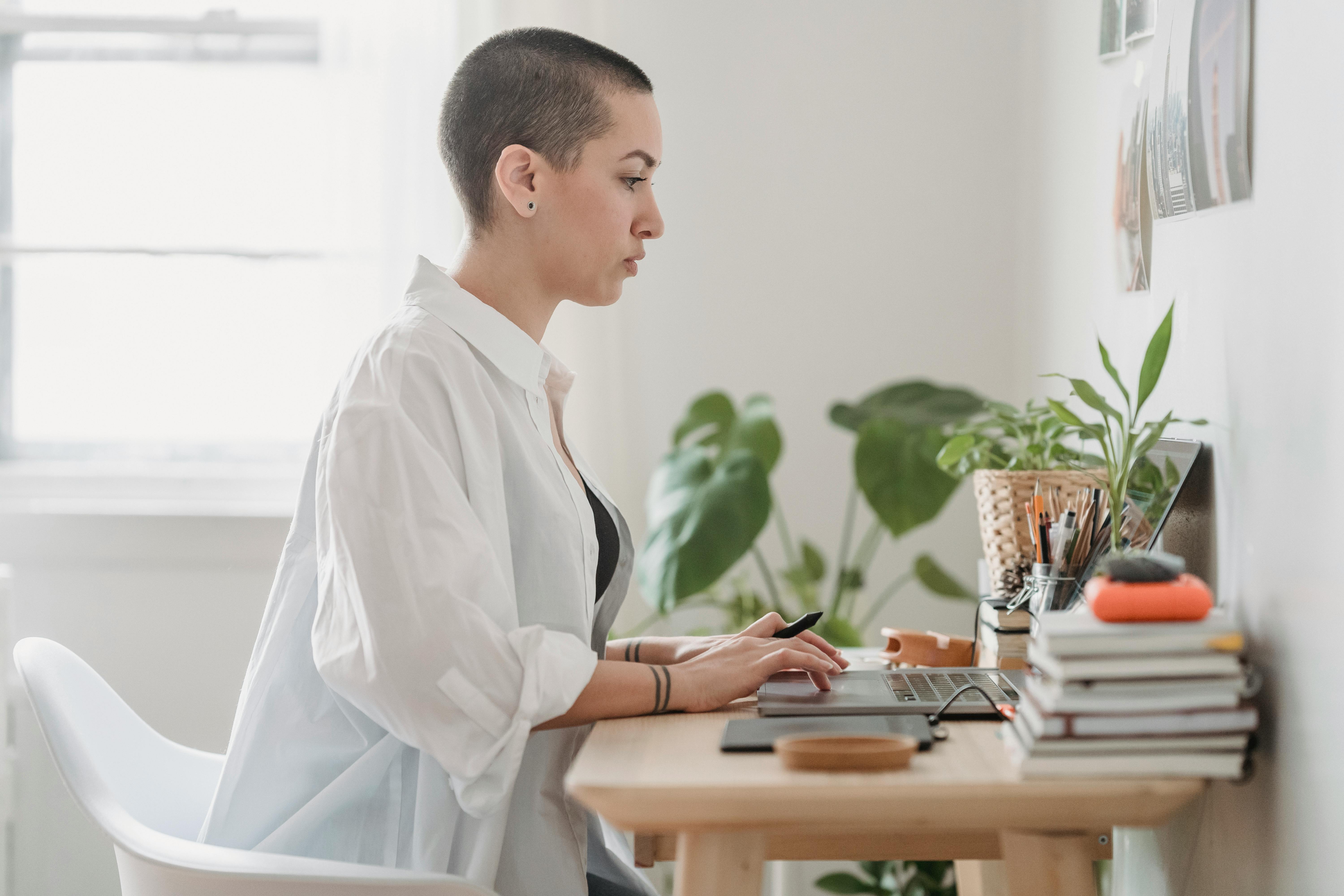 focused woman browsing laptop during distant work