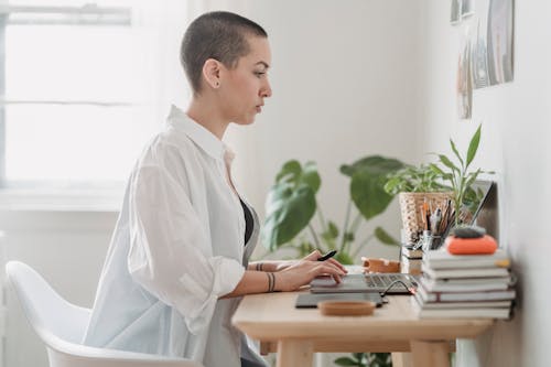 Focused woman browsing laptop during distant work