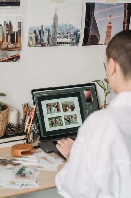 person editing photos on laptop
