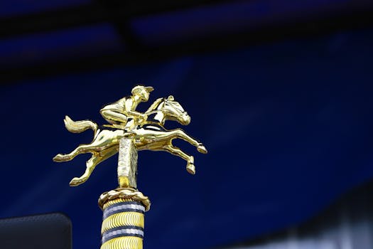Close-up of a golden horse racing trophy with a rich blue background, symbolizing victory.