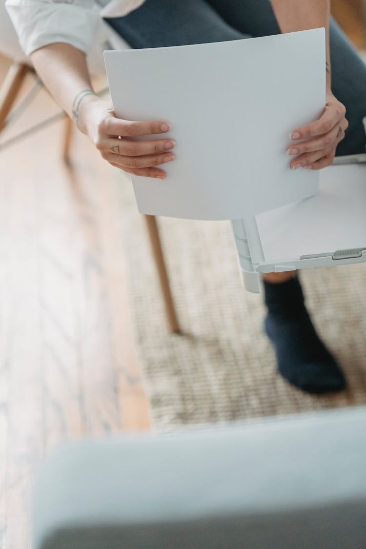 Woman Stacking Paper In Printer For Work