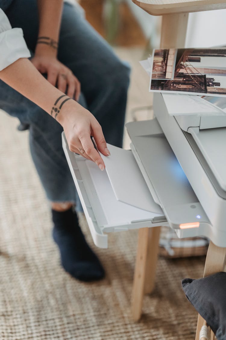 Woman Printing Photos On Paper At Home