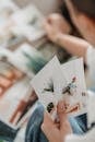 Woman selecting pictures placed on table