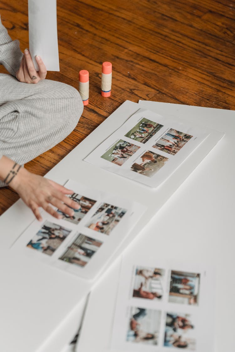 Crop Woman Creating Photography Collage On Paper Sheet