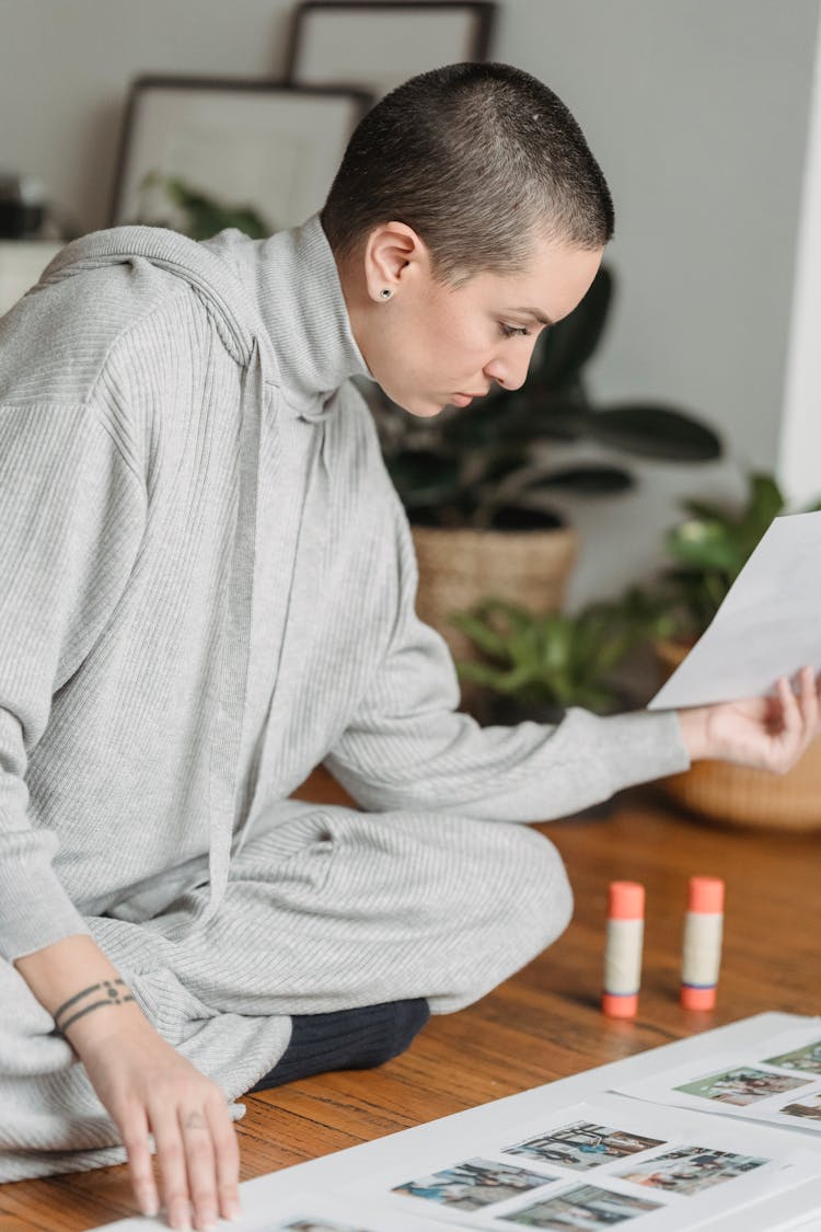 Attentive Woman Creating Photo Collage At Home