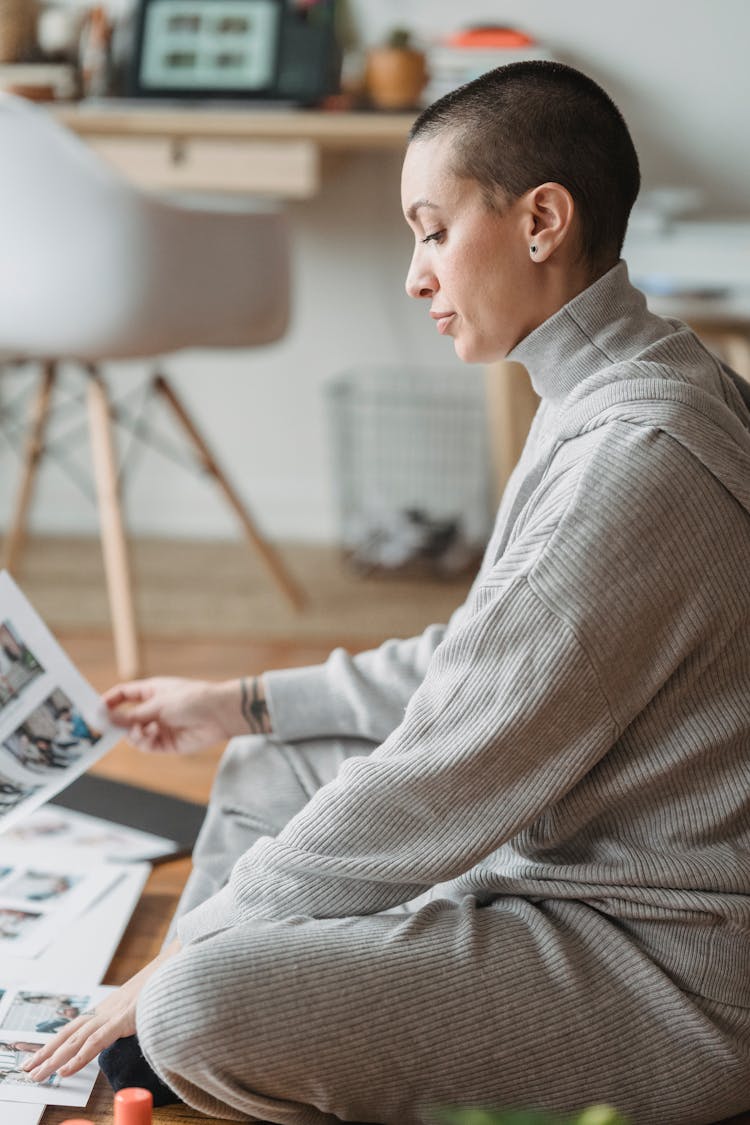 Woman Creating Photo Collage In House Room