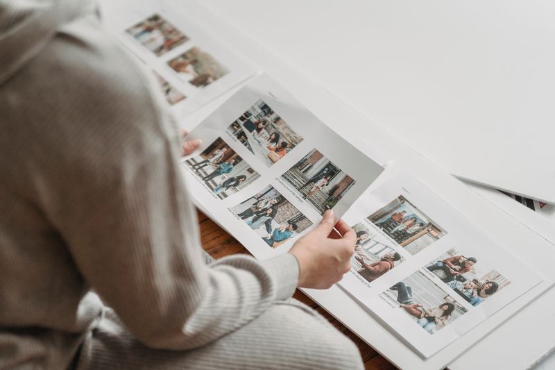 Person looking through a printed photo album