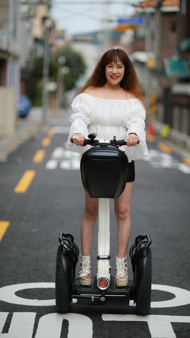 Happy Woman Riding A Scooter 