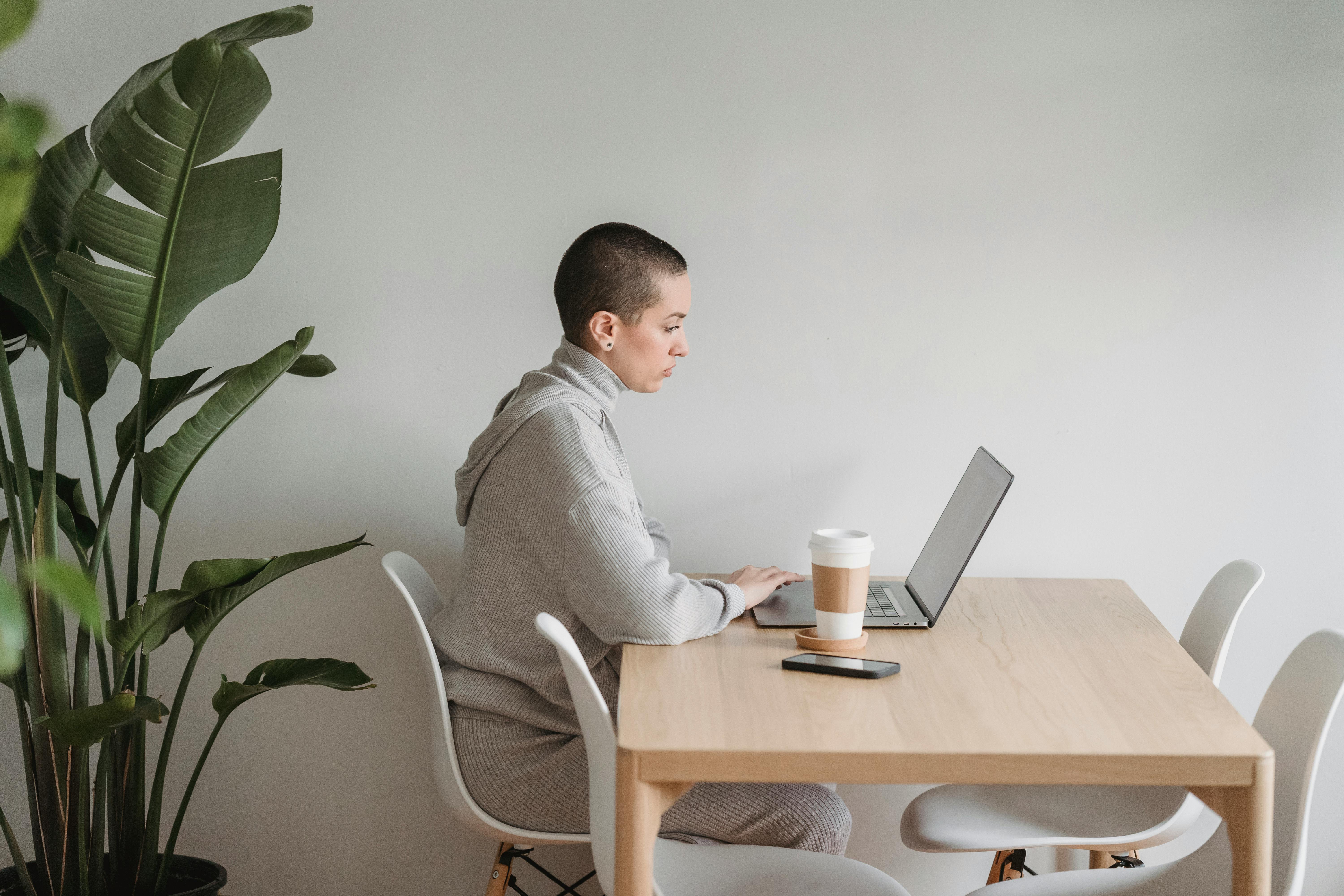 concentrated woman working on laptop in living room