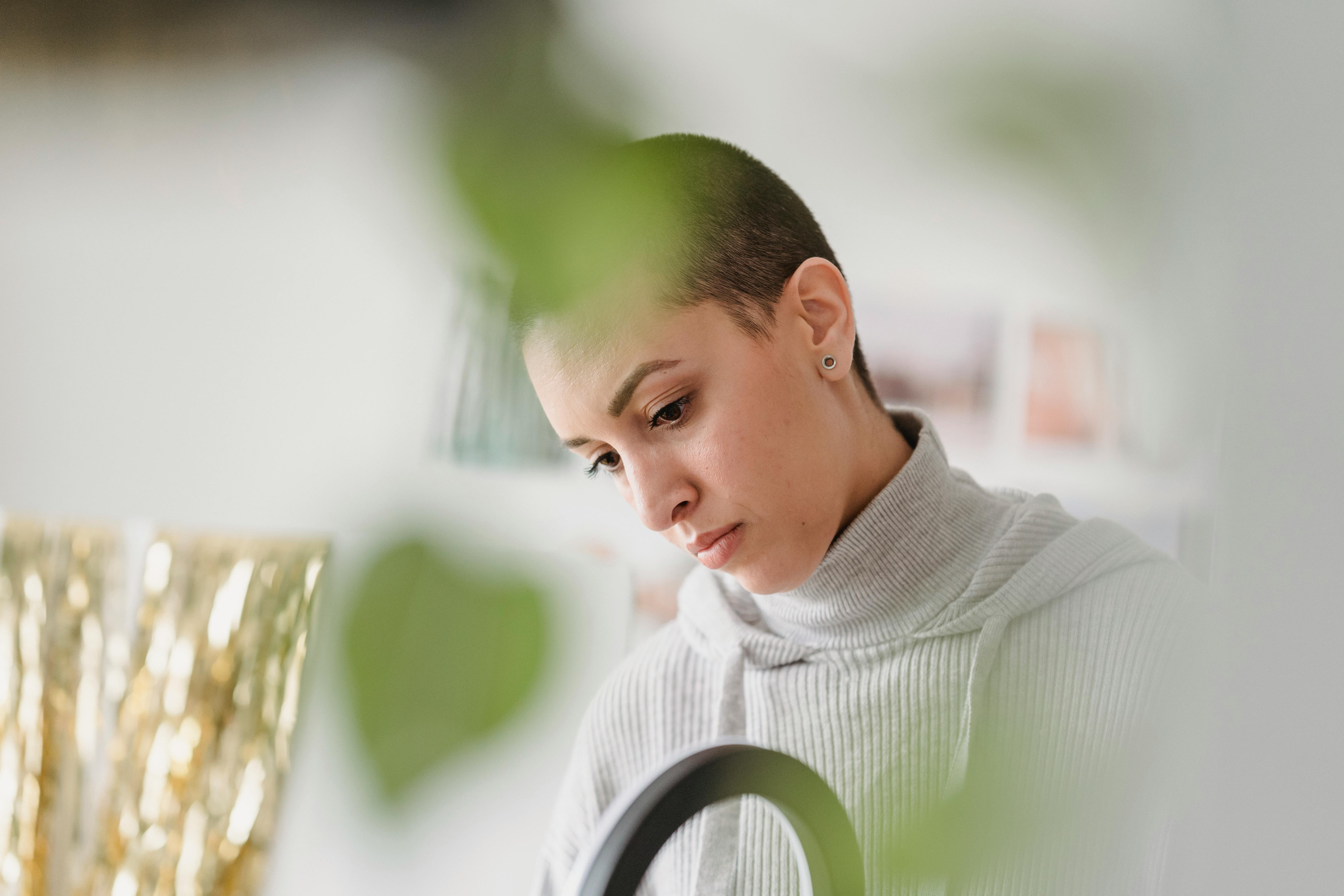 concentrated woman installing ring lamp in house