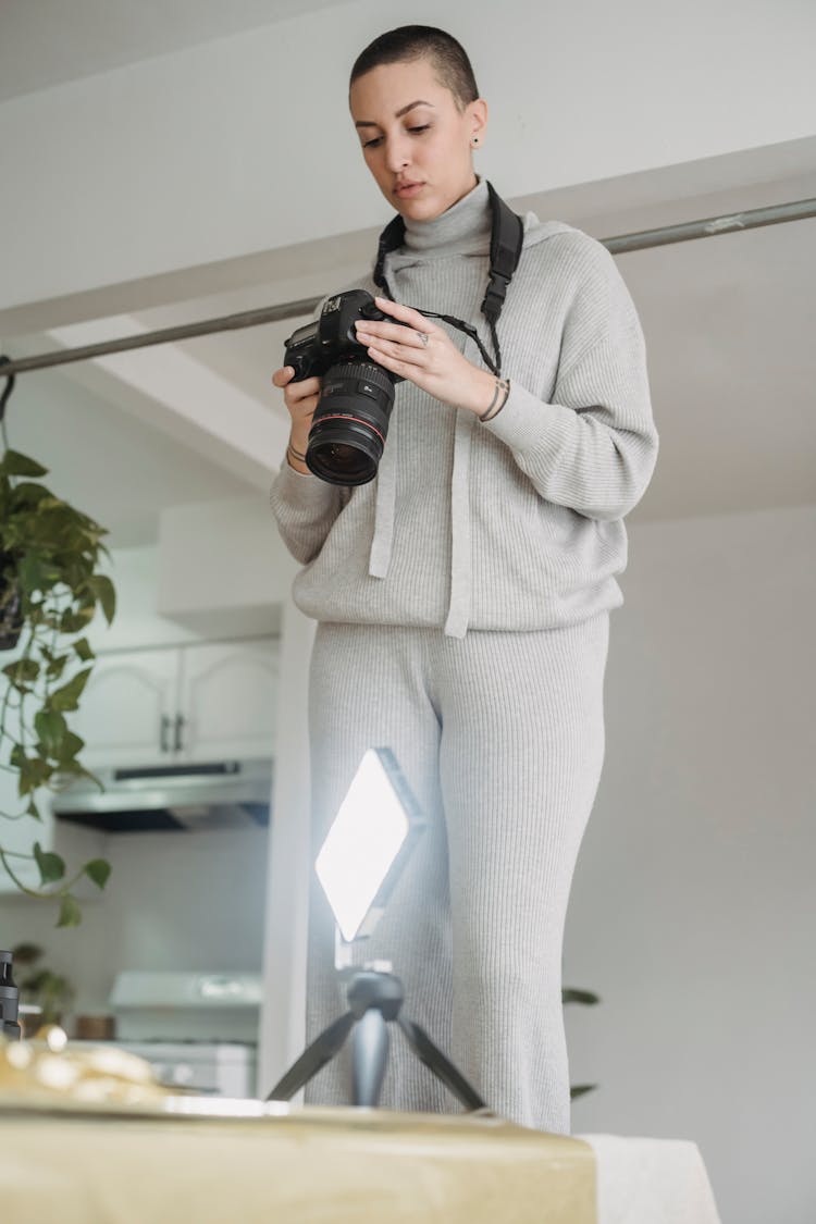 Photographer Setting Up Photo Camera For Shooting