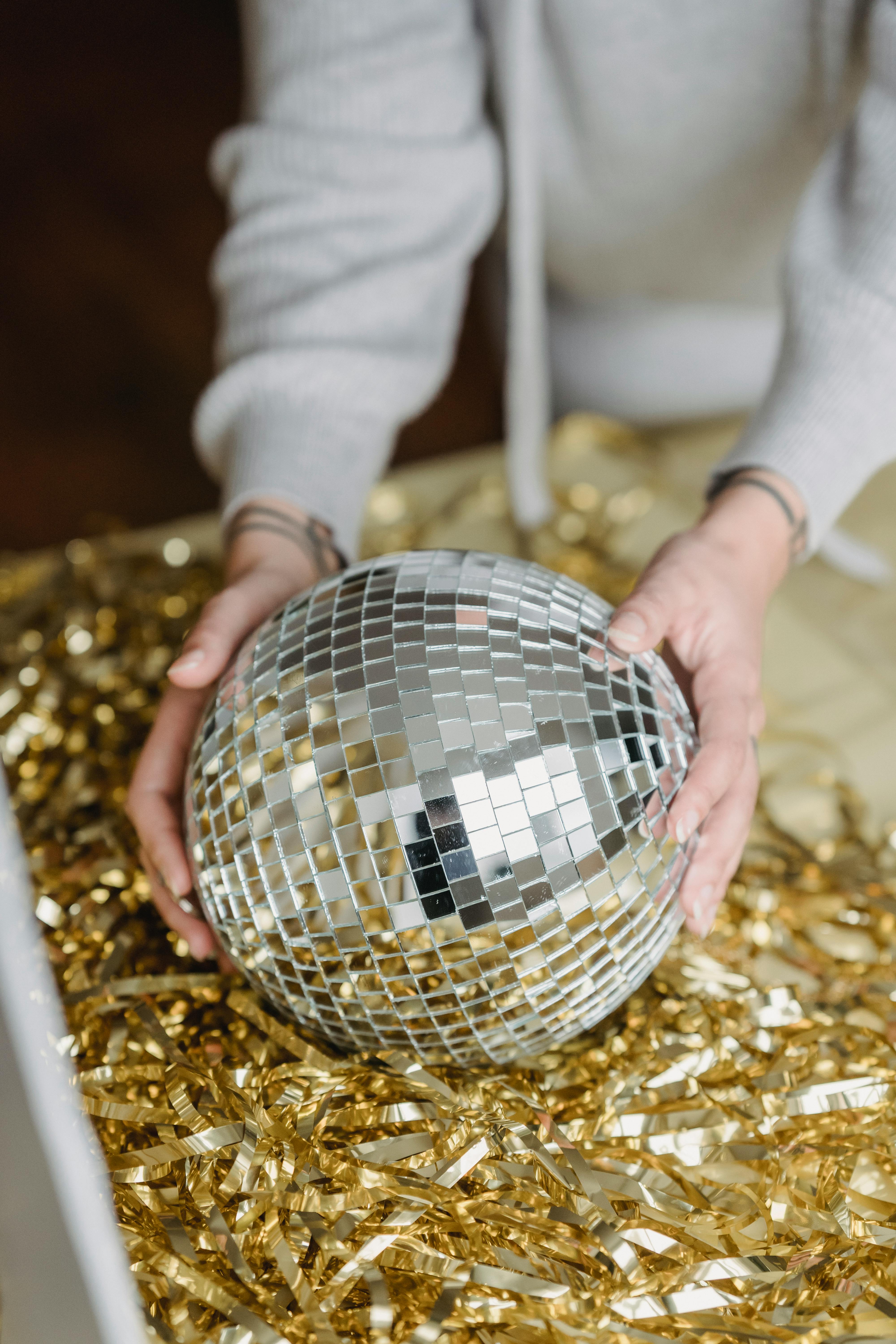 woman putting party ball on golden tinsel