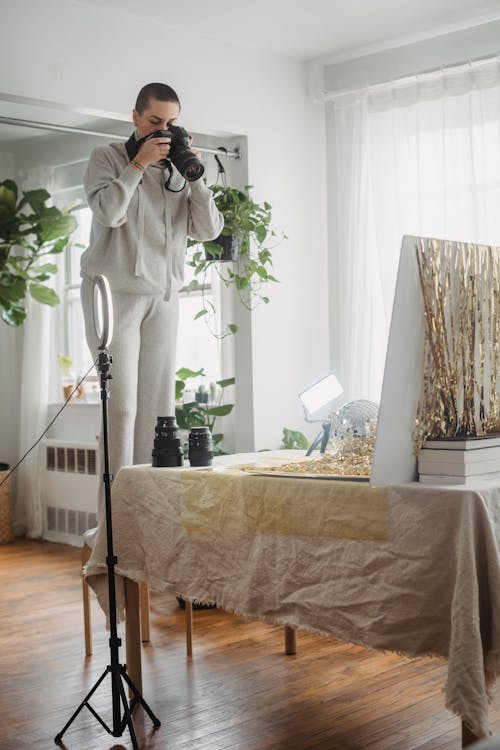 Photographer shooting photo of disco ball and shimmering tinsel