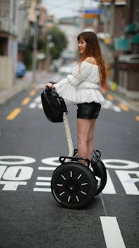 Woman riding a Segway on an urban street. Stylish and modern transportation in a city environment.