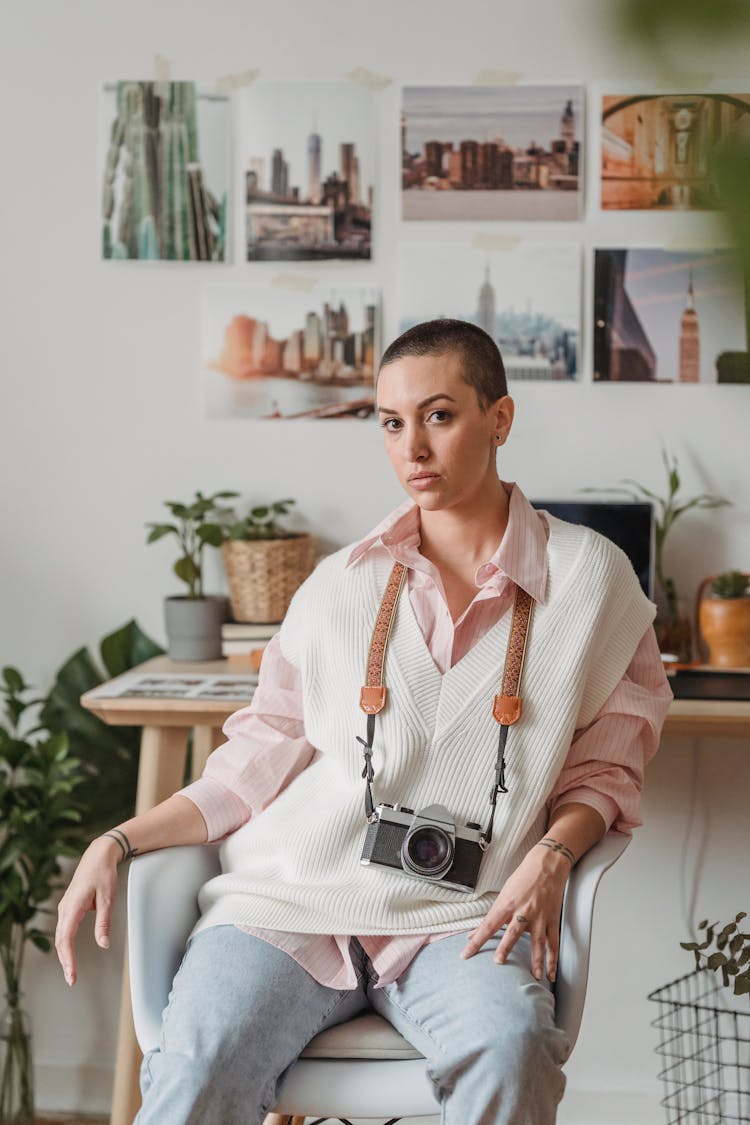 Photographer With Old Photo Camera Resting In Armchair At Home