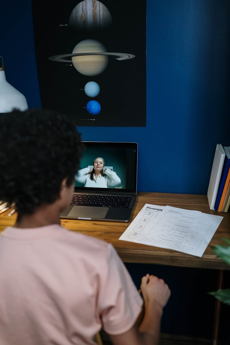 A Student Listening To Online Class