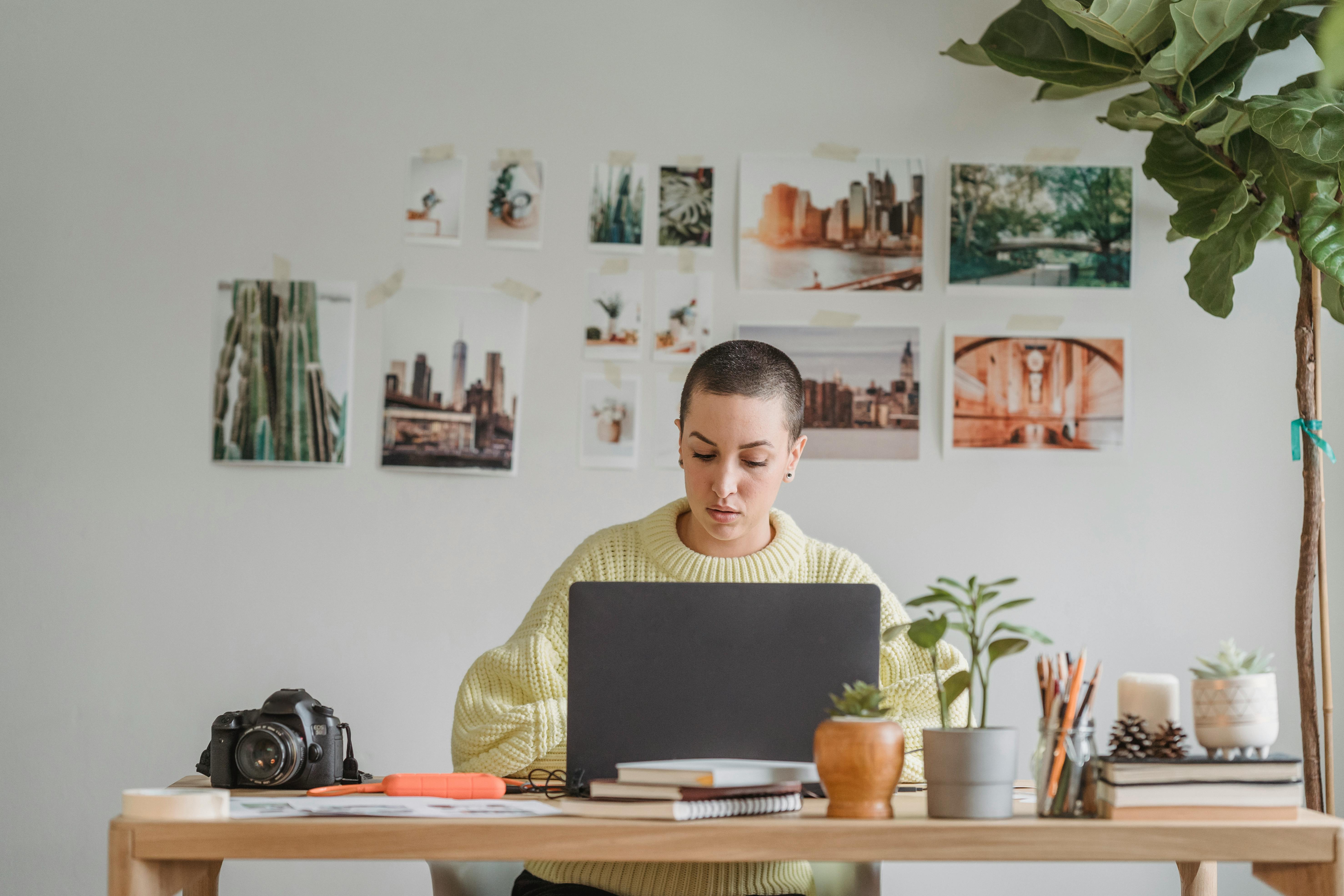 Concentrated woman working on laptop in office