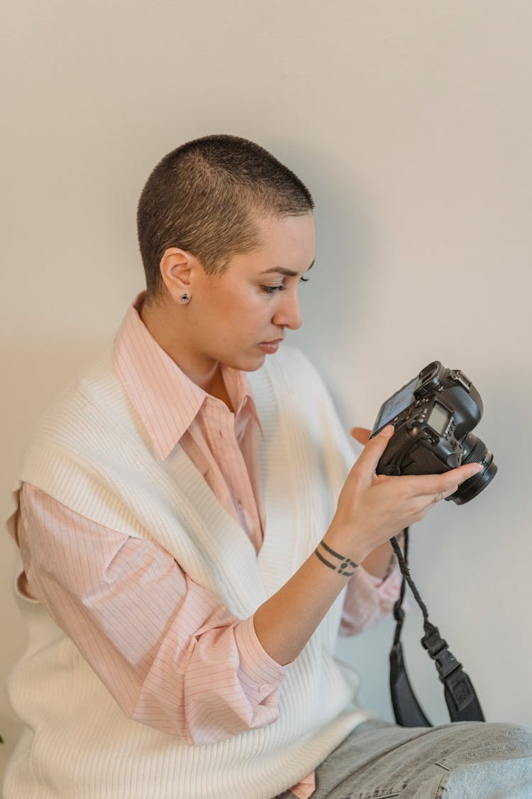 Focused Woman Using Photo Camera In Studio