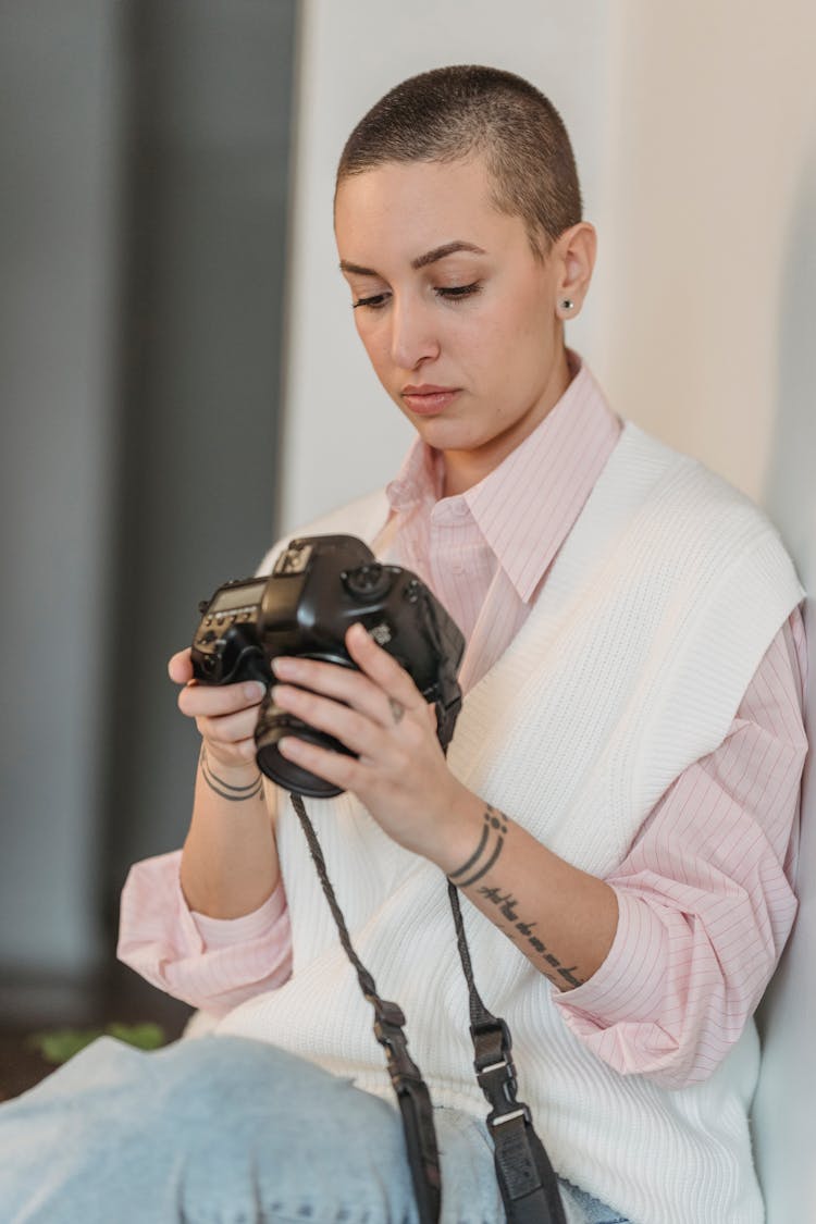 Pensive Woman Looking Through Photos In Photo Camera