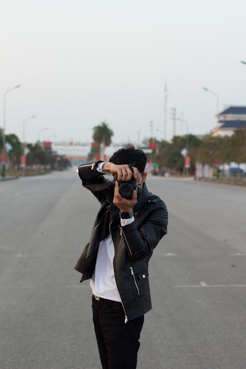 Free Man in Black Leather Jacket Taking Photos Stock Photo