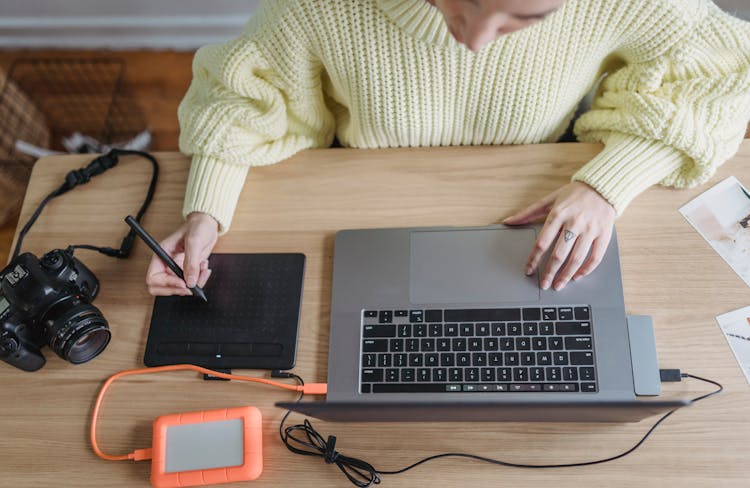 Anonymous Photographer Drawing On Graphic Tablet While Retouching Photos