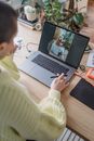 Anonymous woman editing photo on modern laptop