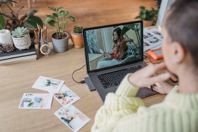 Anonymous Woman Editing Photo On Laptop At Table