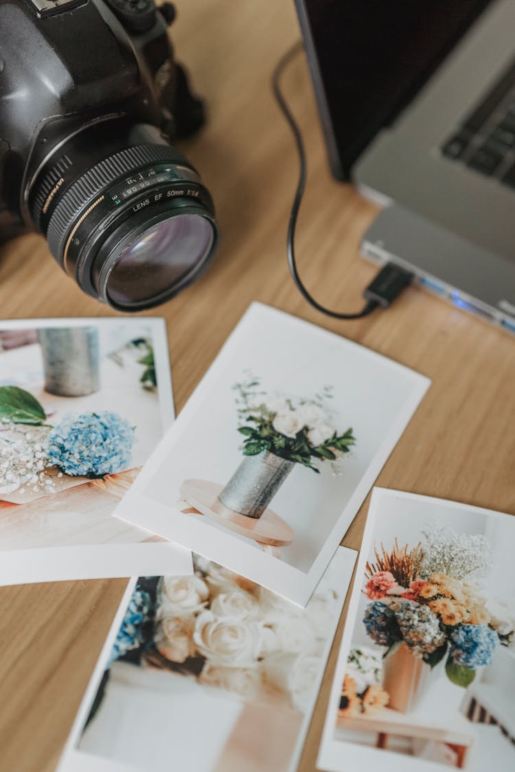 Printed Photos On Table With Photo Camera