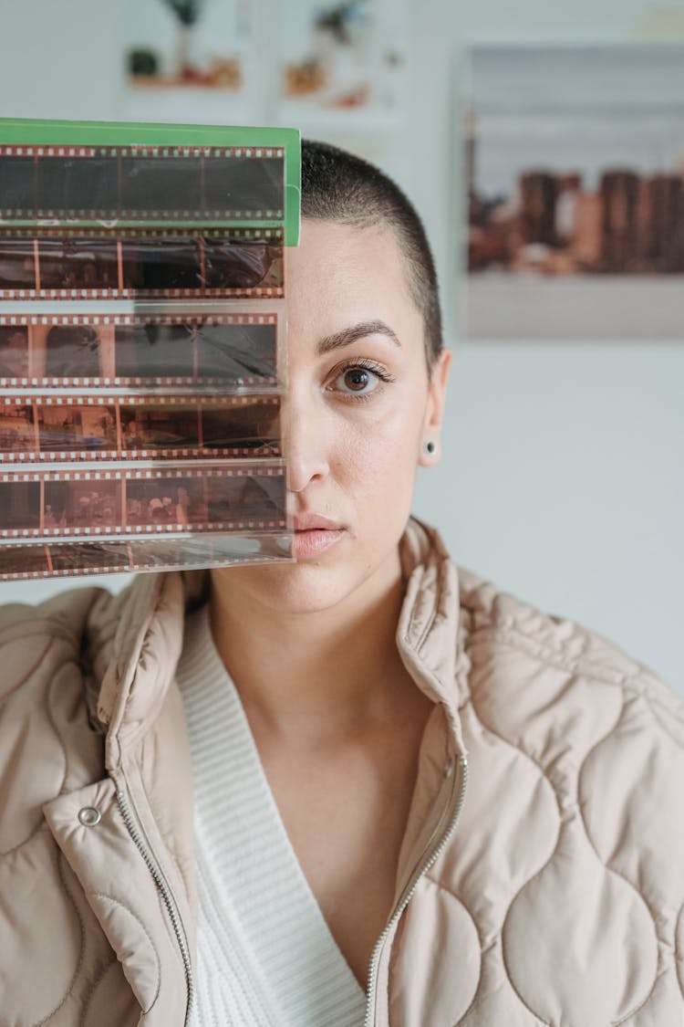 Calm Woman Showing Photo Film Near Face