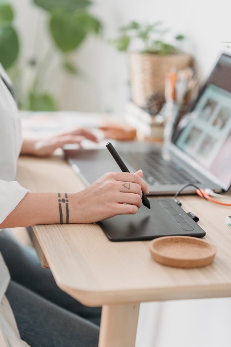 Crop Faceless Woman Working On Laptop And Graphic Tablet