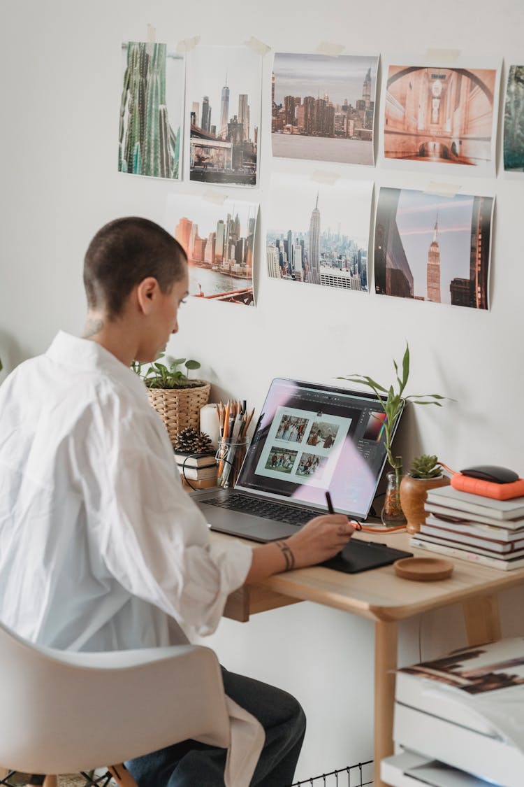 Pensive Woman Editing Photos On Laptop And Graphic Tablet