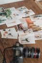Printed photos scattered on wooden table