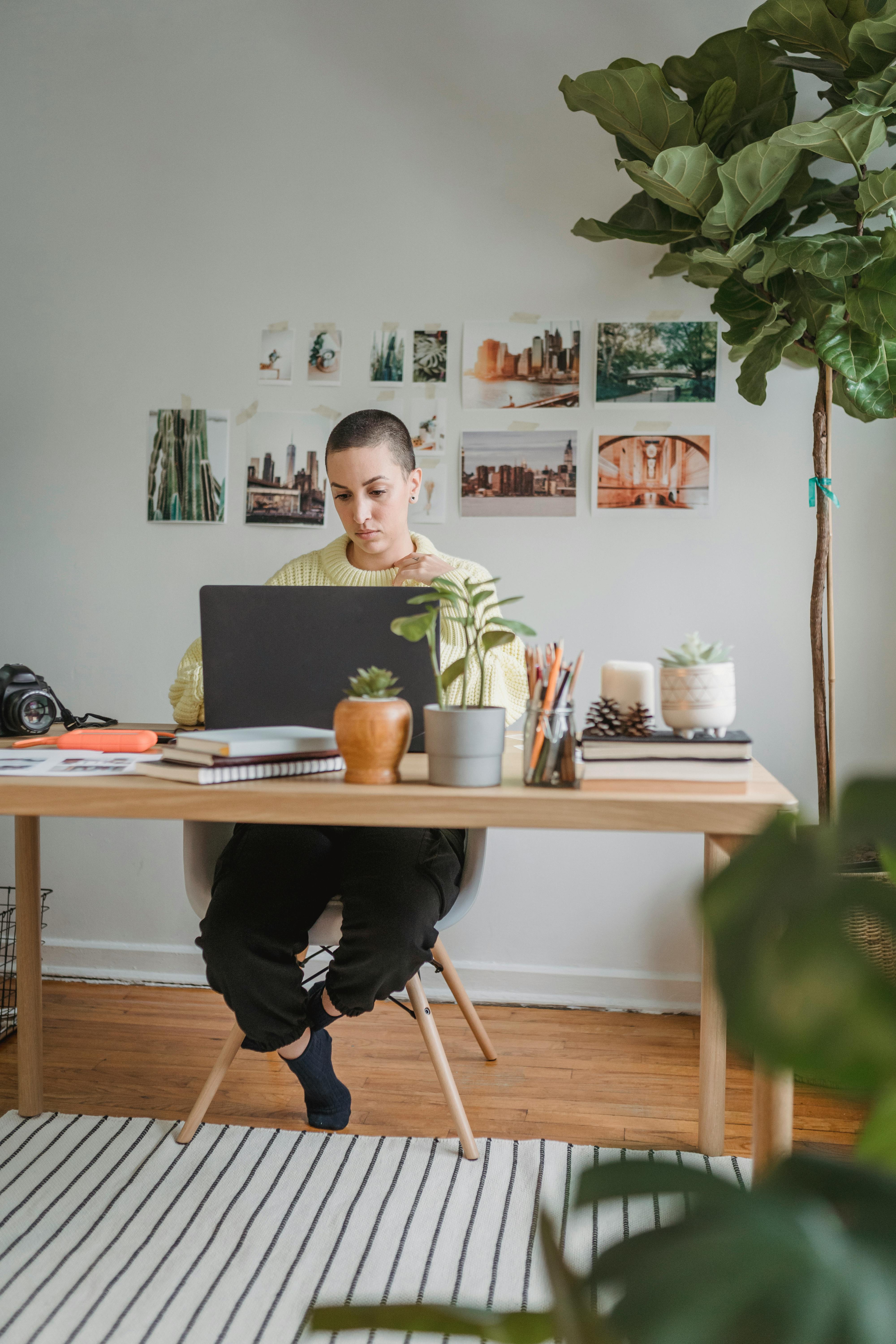 Black female freelancer using computer with dog · Free Stock Photo