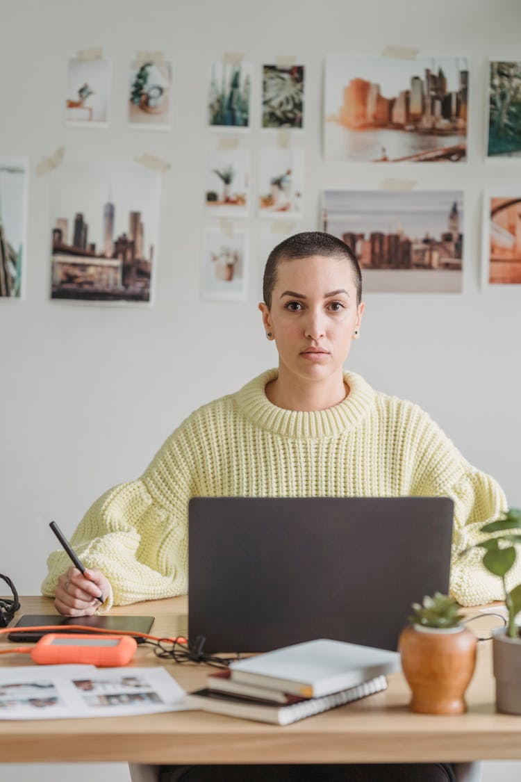 Thoughtful Female Designer With Laptop And Graphic Tablet