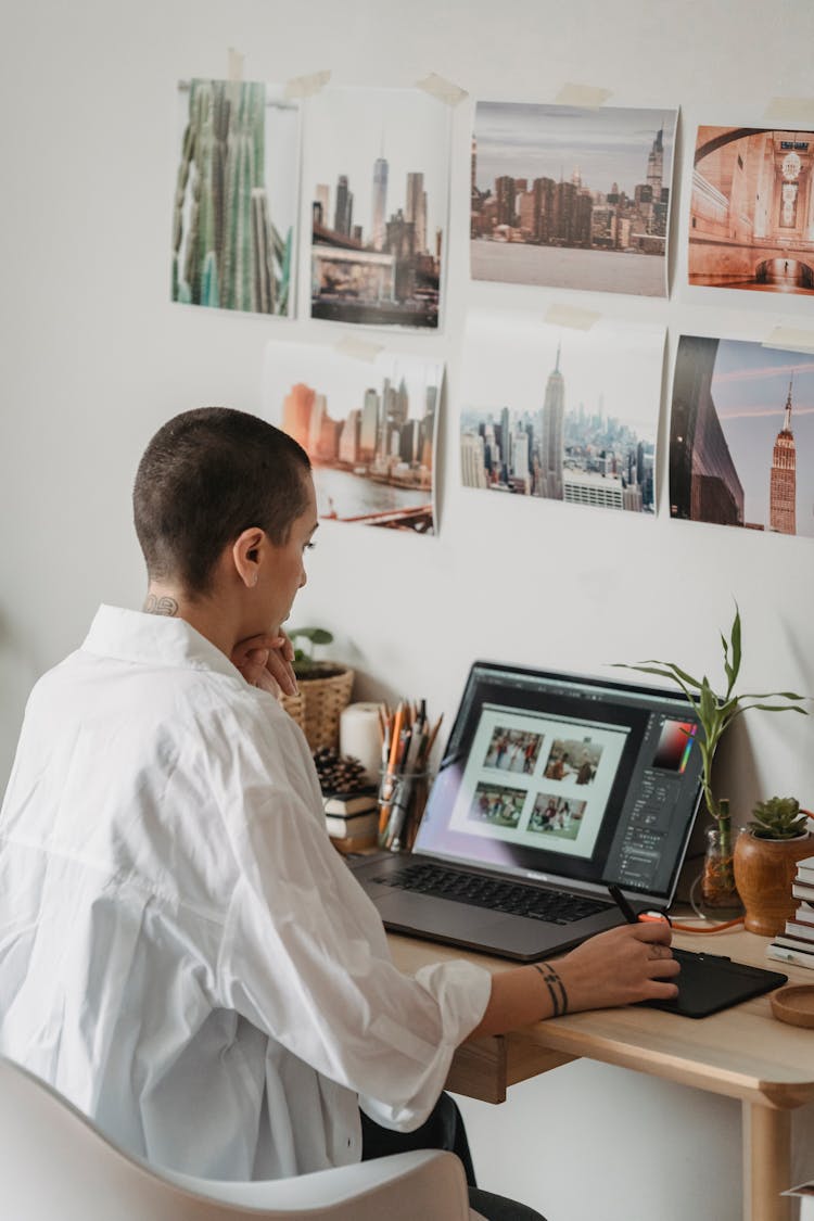 Serious Woman Editing Photos On Laptop