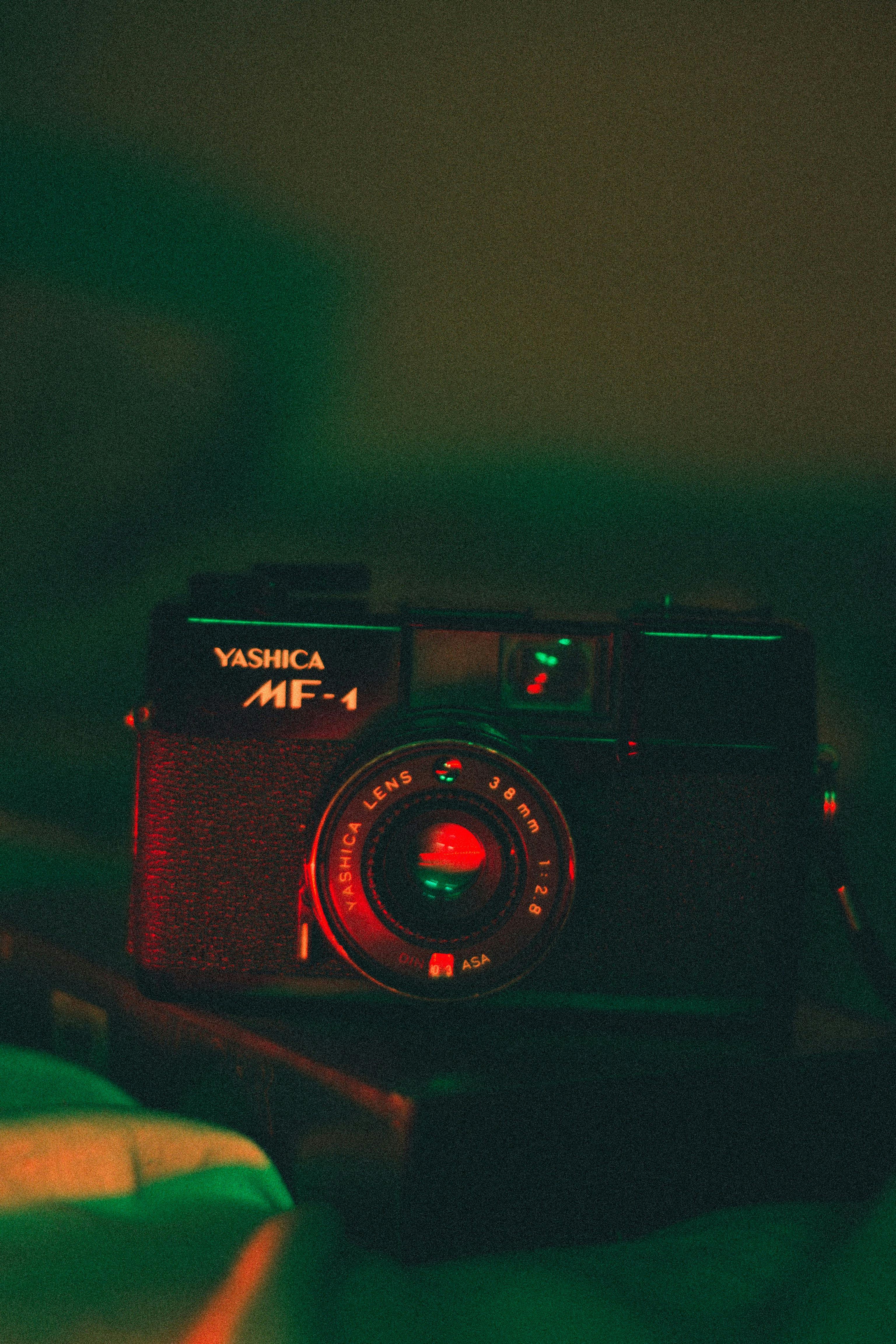 Artistic close-up of a vintage Yashica camera with moody lighting and retro vibes.