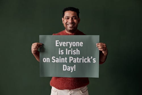 Man Holding a Placard on Green Background
