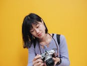 Woman in Purple Sweater Looking at the Digital Camera