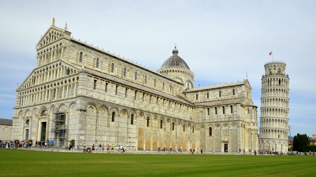 View of Pisa Cathedral and the iconic Leaning Tower, a historic tourist attraction in Italy.