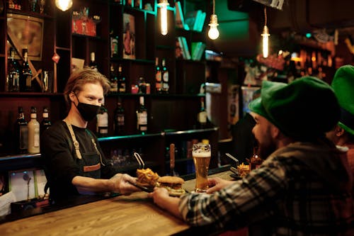 A Barman Serving Food to the Customer