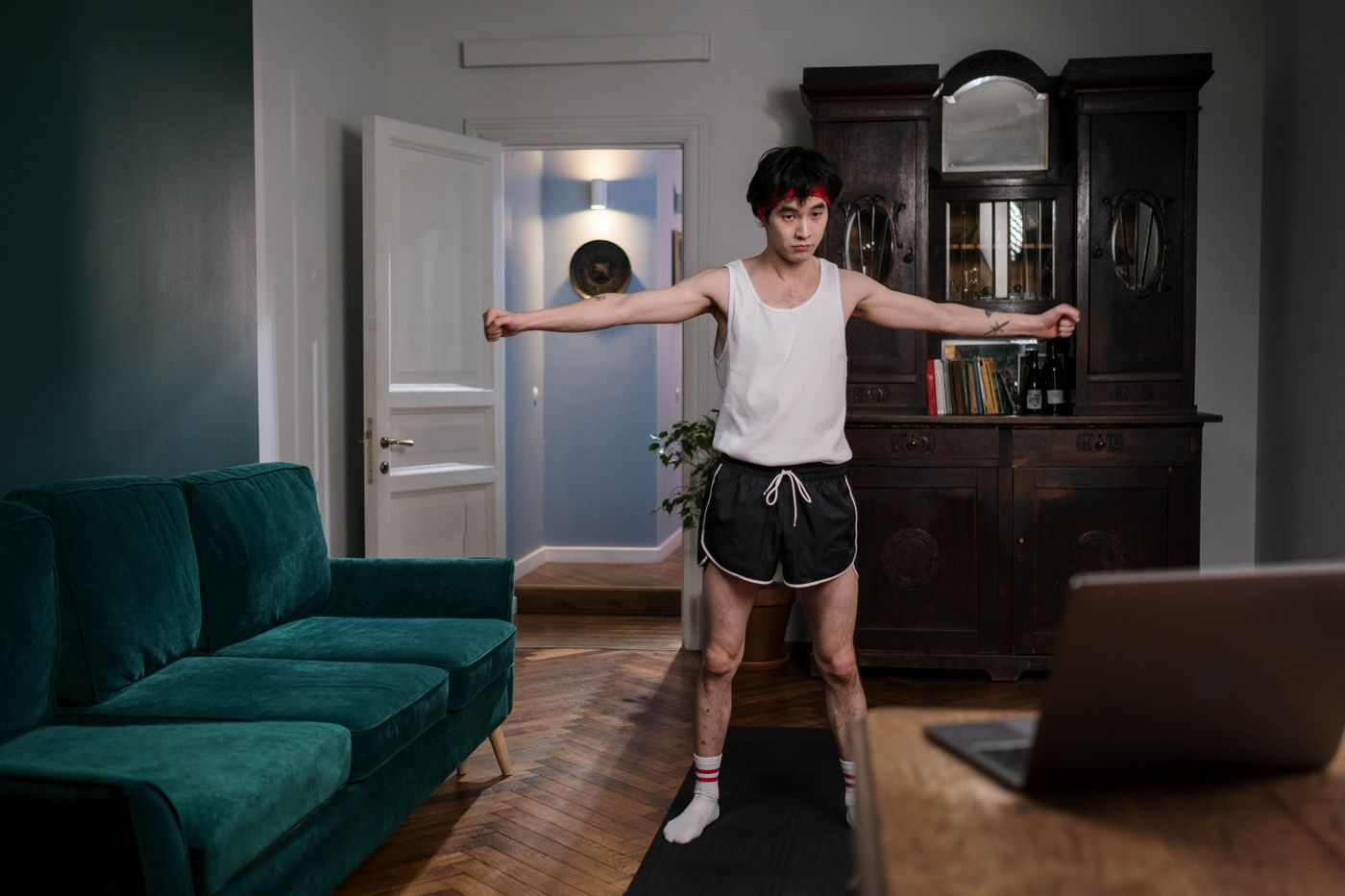 Man performing bodyweight strength exercises at home