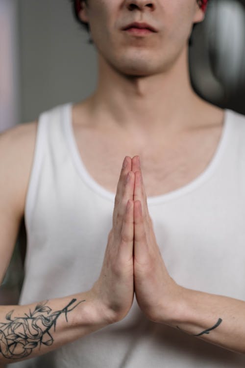 Free A Person Meditating with Hands in Praying Position Stock Photo