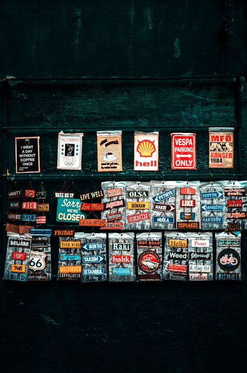 Free Various retro art posters on weathered wall on street Stock Photo