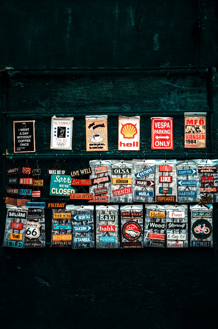 Various Retro Art Posters On Weathered Wall On Street