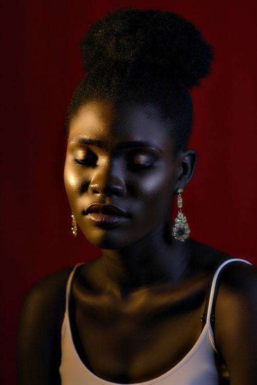 Free Elegant studio portrait of a woman with her eyes closed on a dark background. Tranquil and serene. Stock Photo