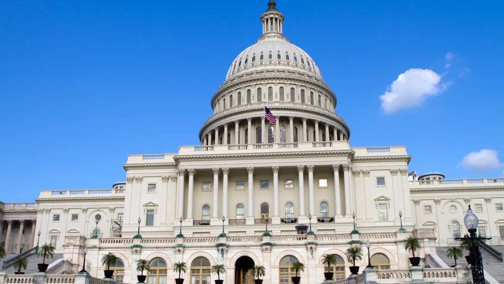 Front of the U.S. Capitol building under a clear blue sky