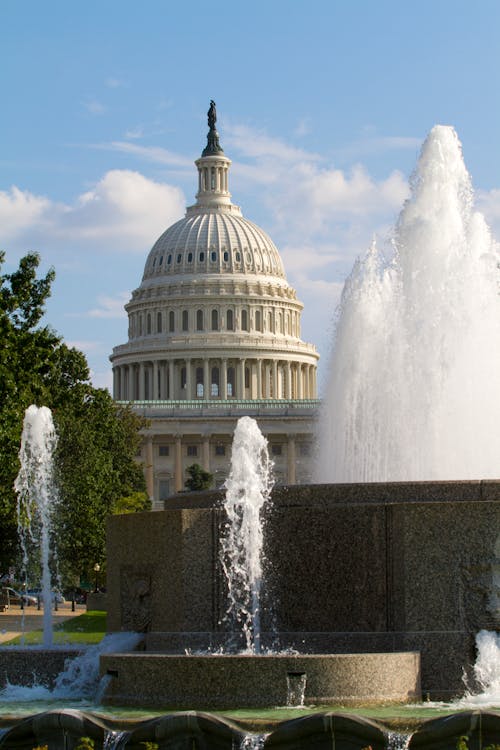 Free A Water Fountain Across the Capitol Building Stock Photo
