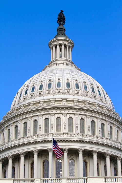 Free Close-up of the iconic dome of the United States Capitol building in Washington, DC against a clear blue sky. Stock Photo