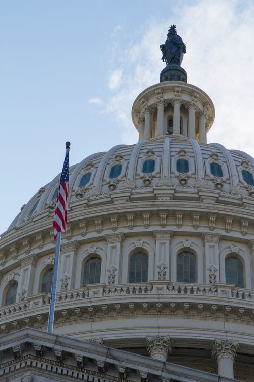 Free Close-up of the iconic Capitol Dome with American flag in Washington, DC, symbolizing government and history. Stock Photo