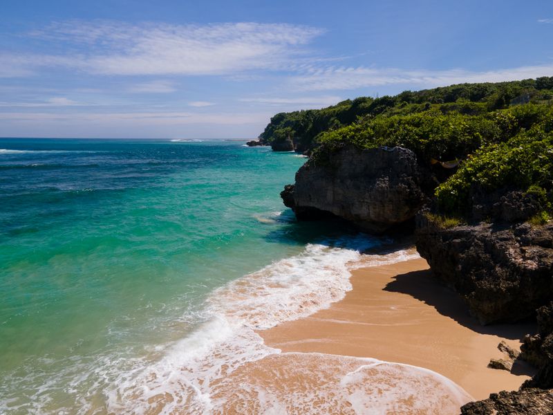 Turquoise waves on a hidden Bali beach